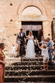 Bride and groom on the steps of a ceremony venue