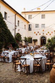 Wedding dinner tables in a villa courtyard